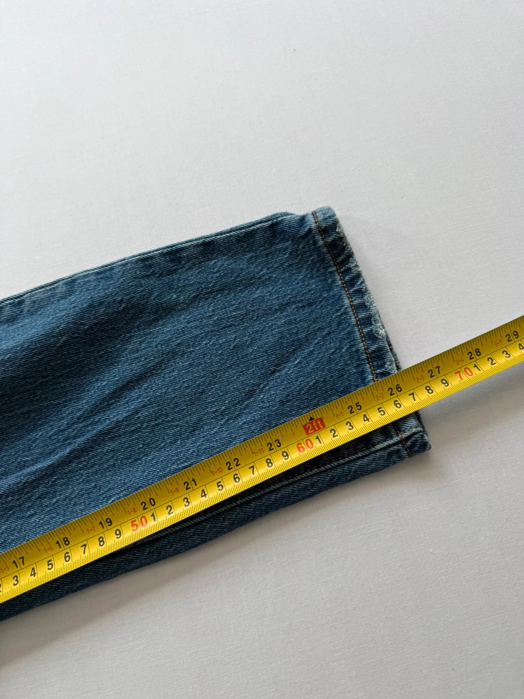 Levi's mid blue straight jeans with button fly and leather-look back patch.