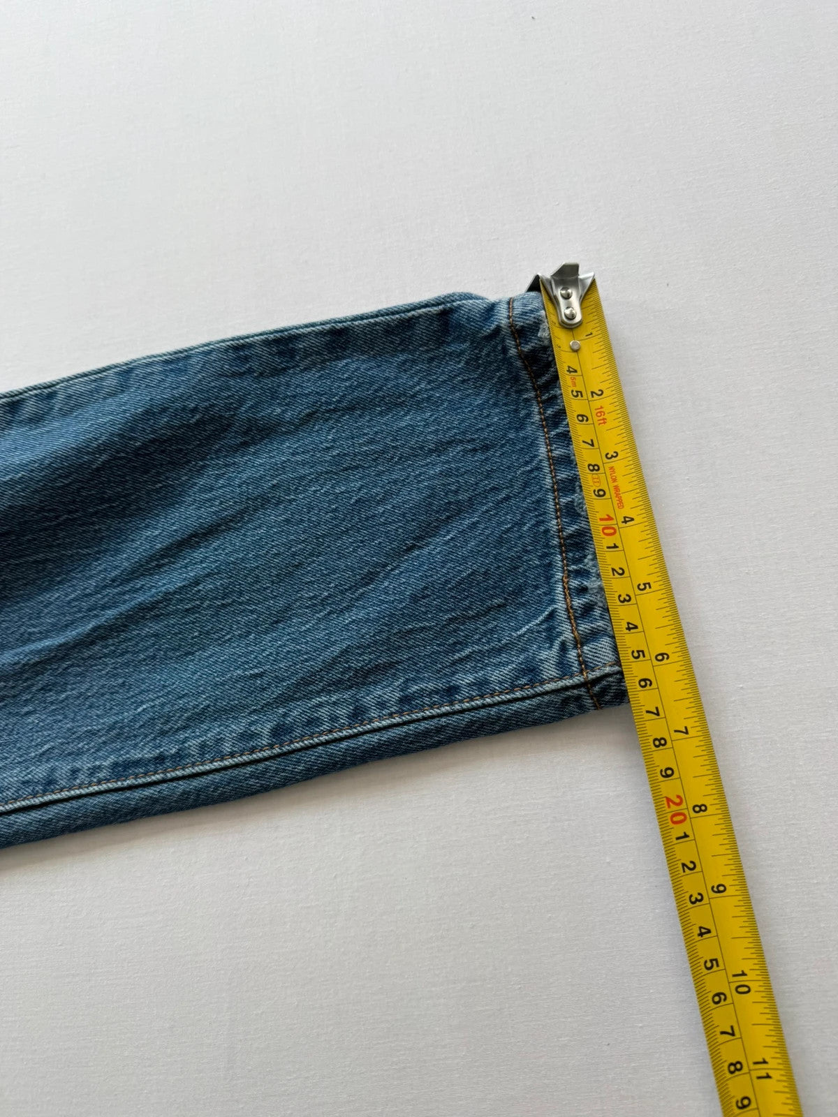 Levi's mid blue straight jeans with button fly and leather-look back patch.