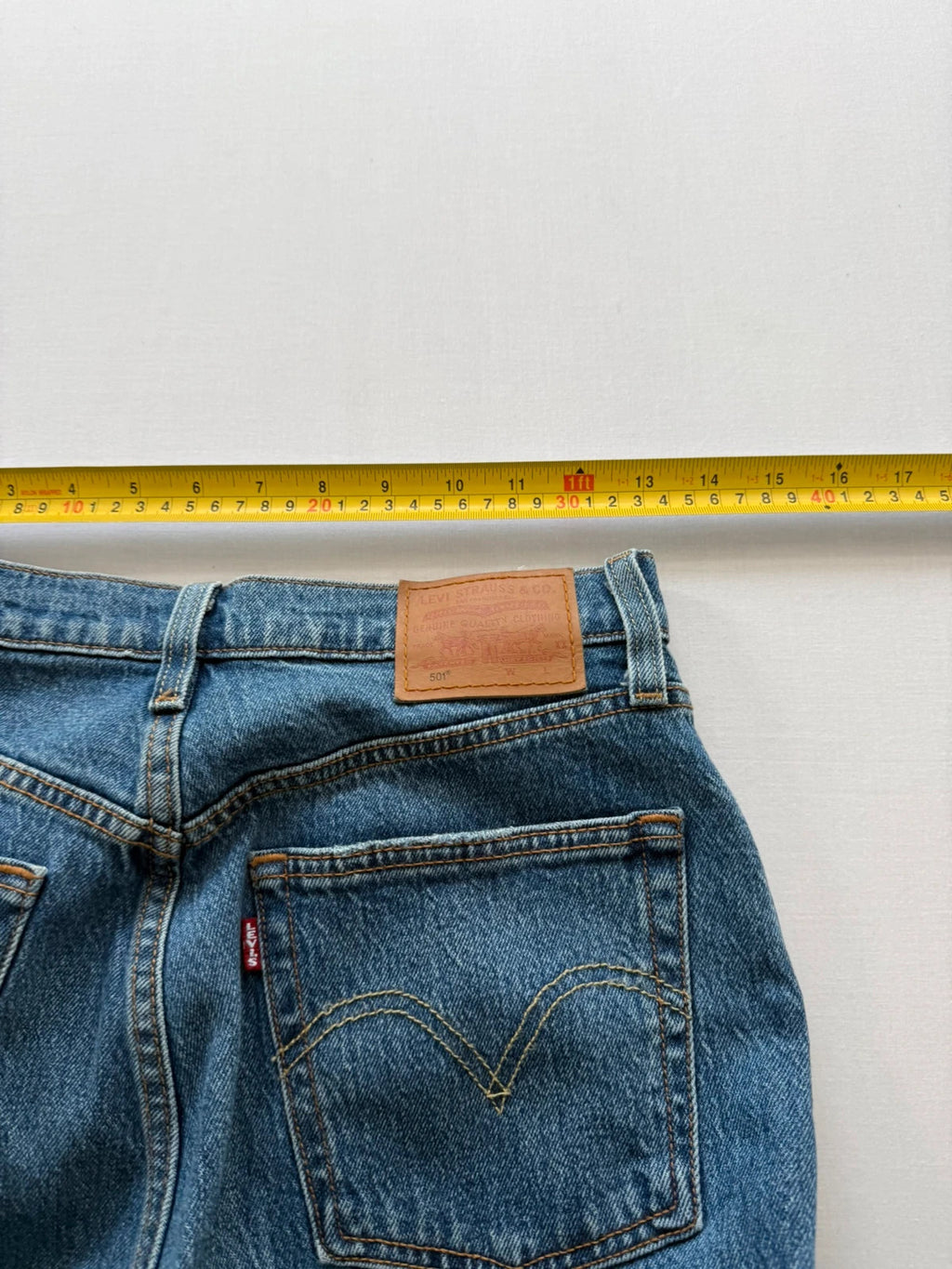 Levi's mid blue straight jeans with button fly and leather-look back patch.