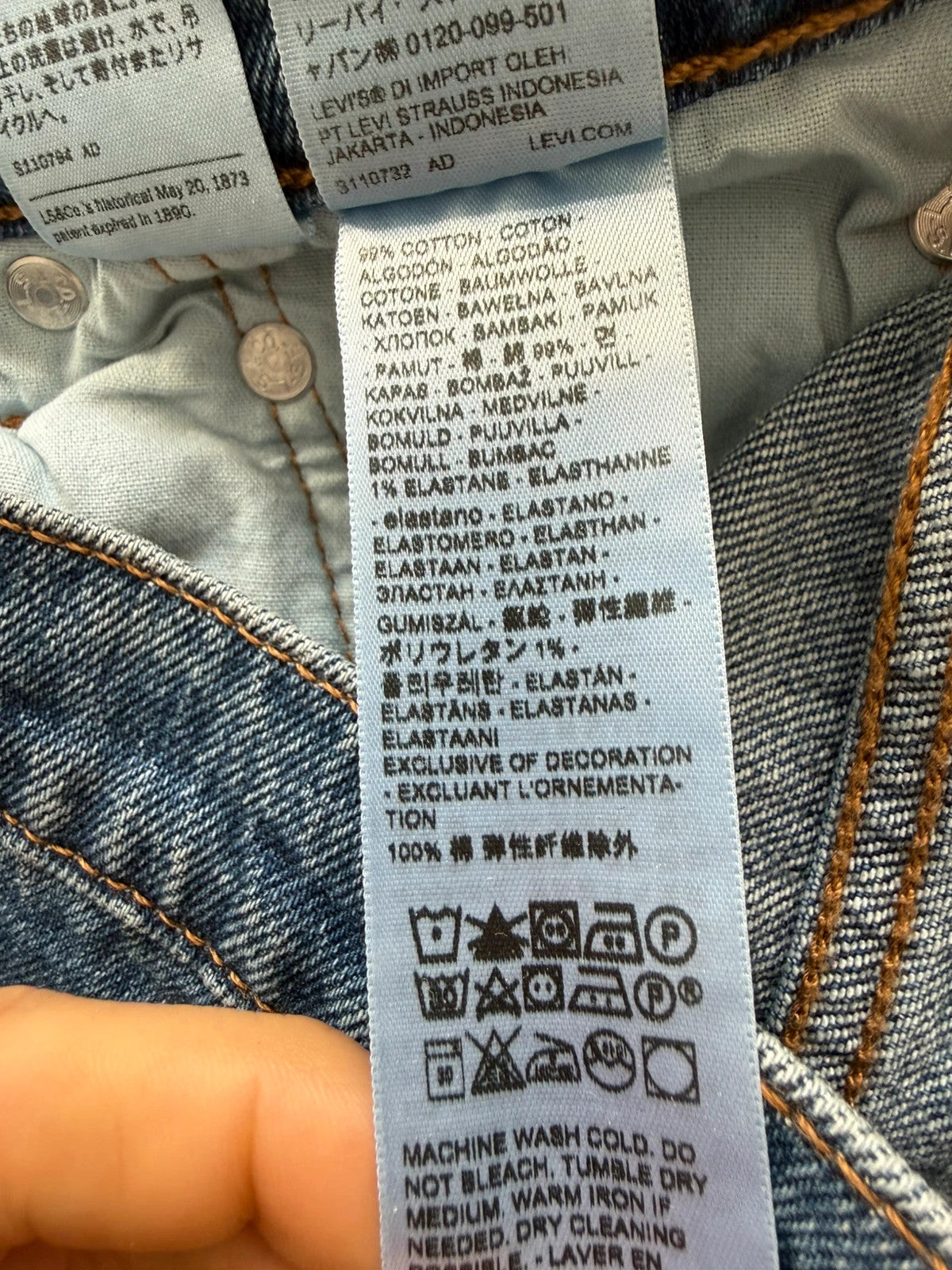 Levi's mid blue straight jeans with button fly and leather-look back patch.