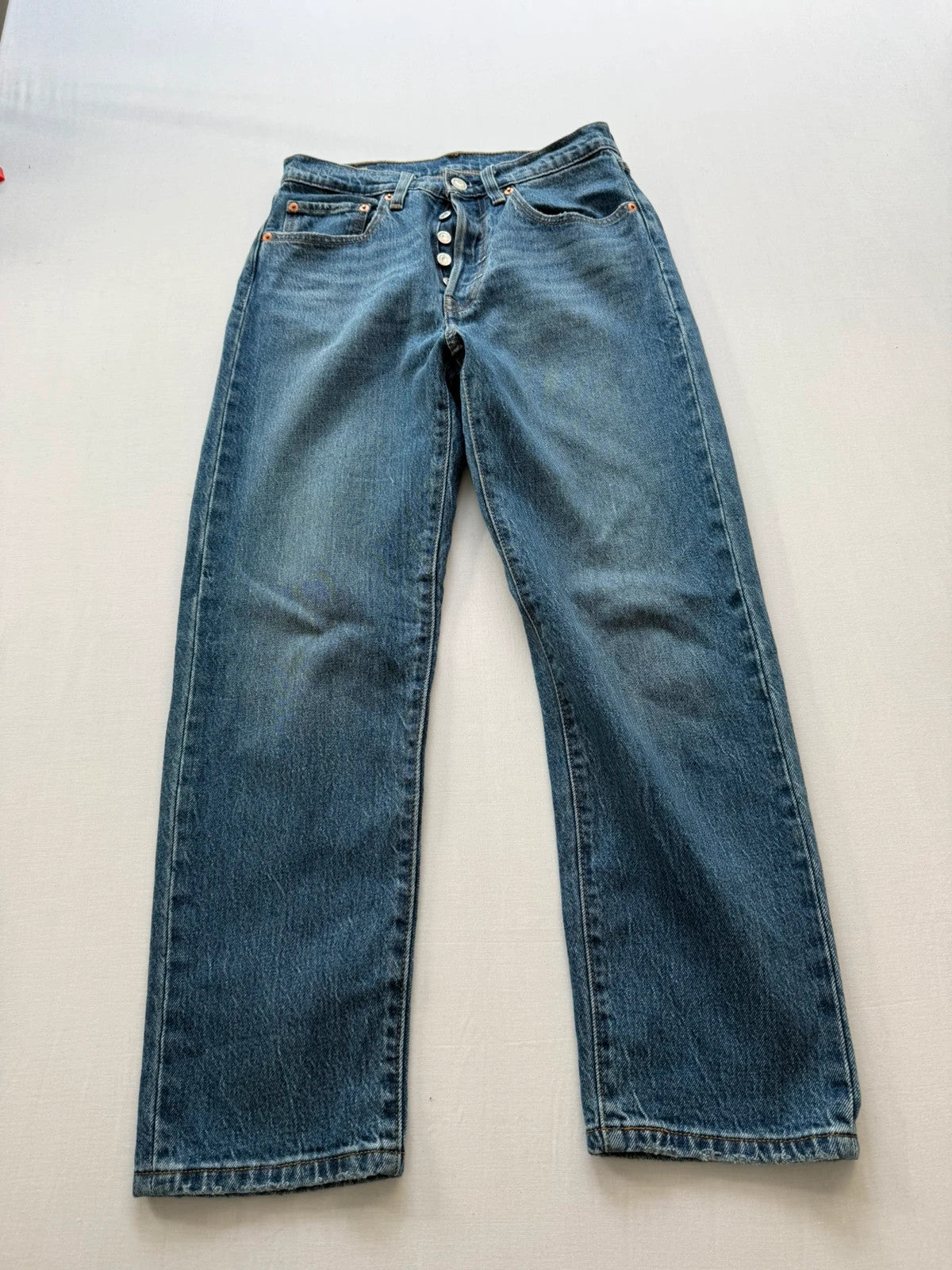 Levi's mid blue straight jeans with button fly and leather-look back patch.
