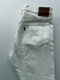 Levi's cream high rise skinny jeans with button fly and rigid cotton denim.