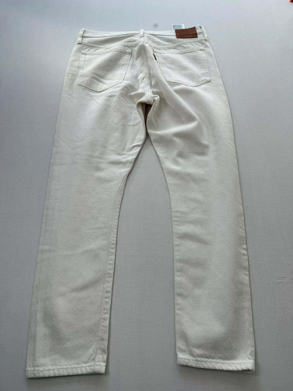 Levi's cream high rise skinny jeans with button fly and rigid cotton denim.